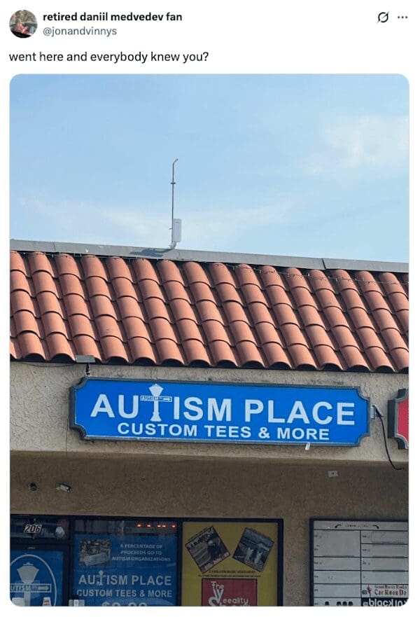Storefront sign for Autism Place Custom Tees with a viral roast caption.