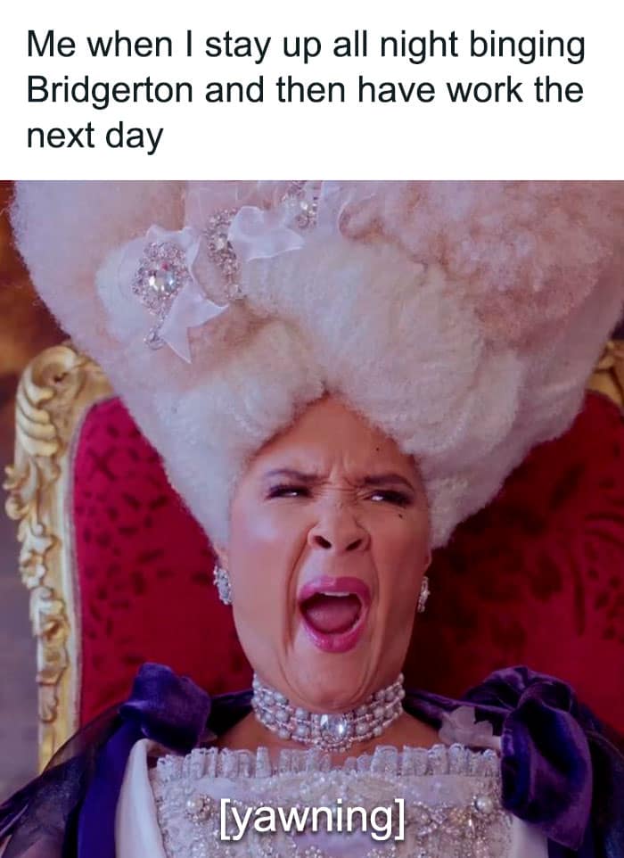Queen Charlotte yawning widely in her extravagant wig. A highly relatable Bridgerton meme about staying up all night binge-watching the show before work.