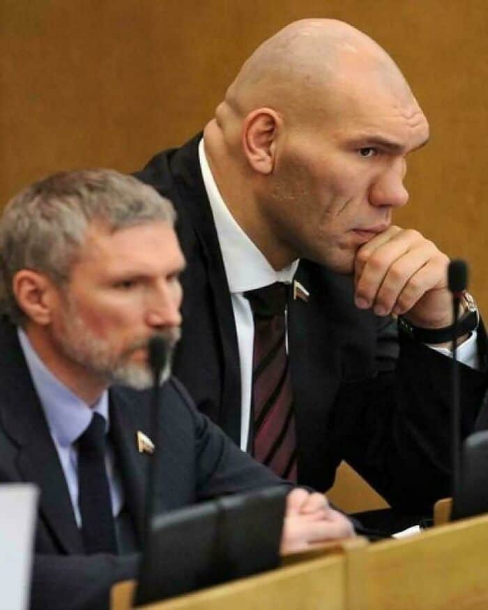 Close up of former boxer Nikolai Valuev sitting at a desk looking intensely focused and massive.