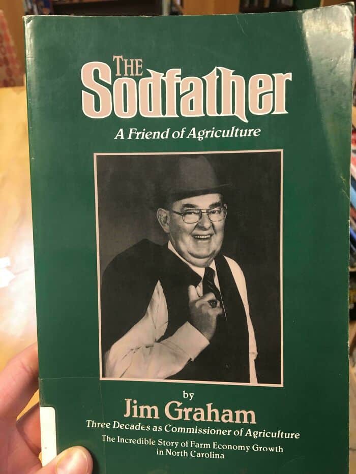 A non-fiction book cover titled "The Sodfather" featuring a man in a hat described as a friend of agriculture.