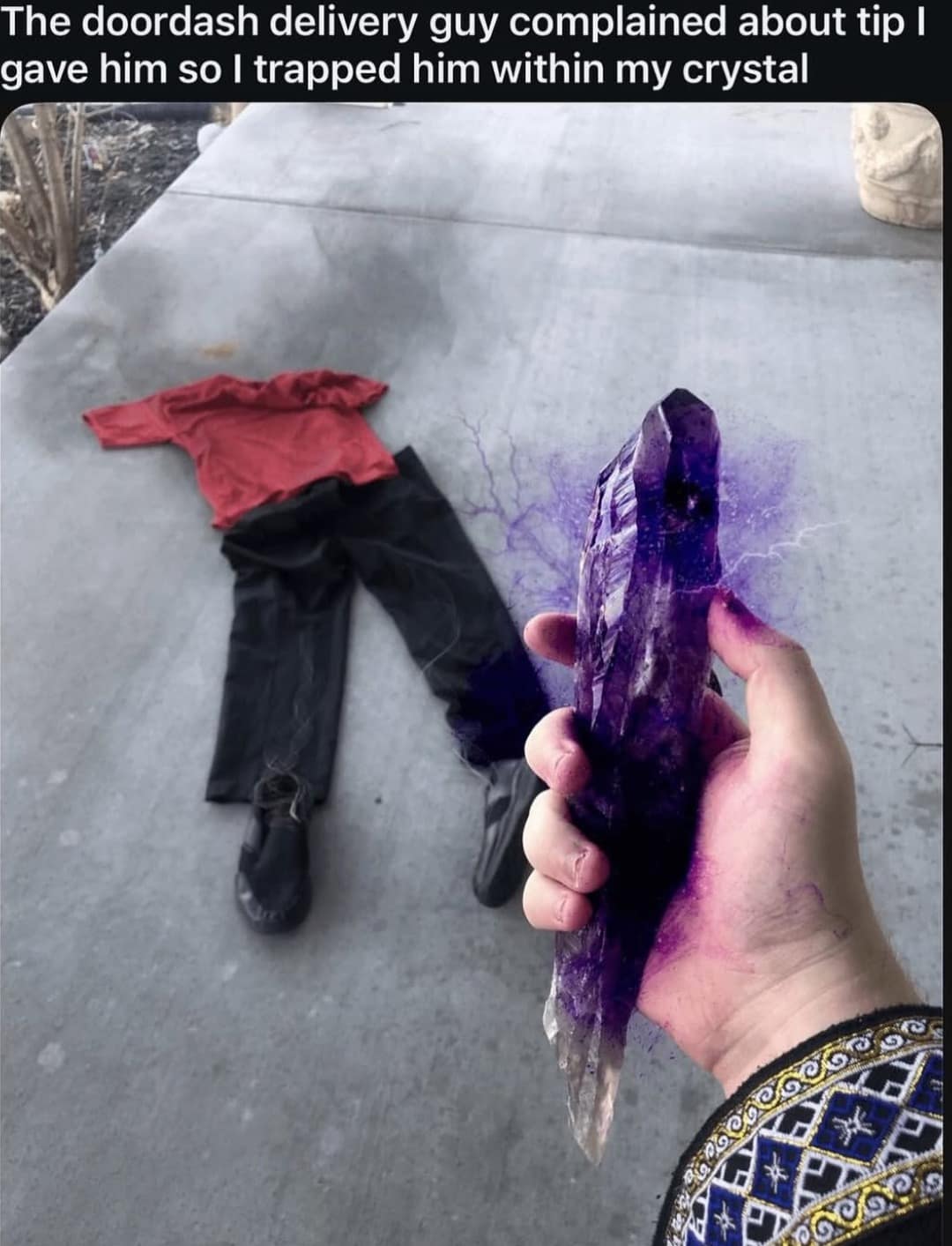 Hand holding a glowing purple crystal next to empty clothes. Wizard joke about trapping a complaining DoorDash delivery guy.
