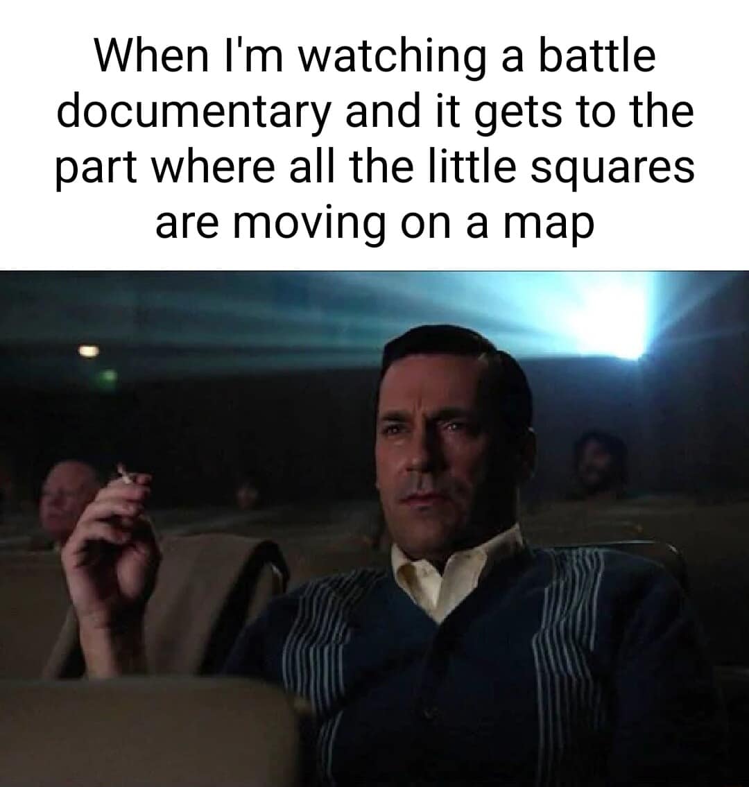 Don Draper smoking in a theater representing the intense focus of watching squares move on a battle documentary map.