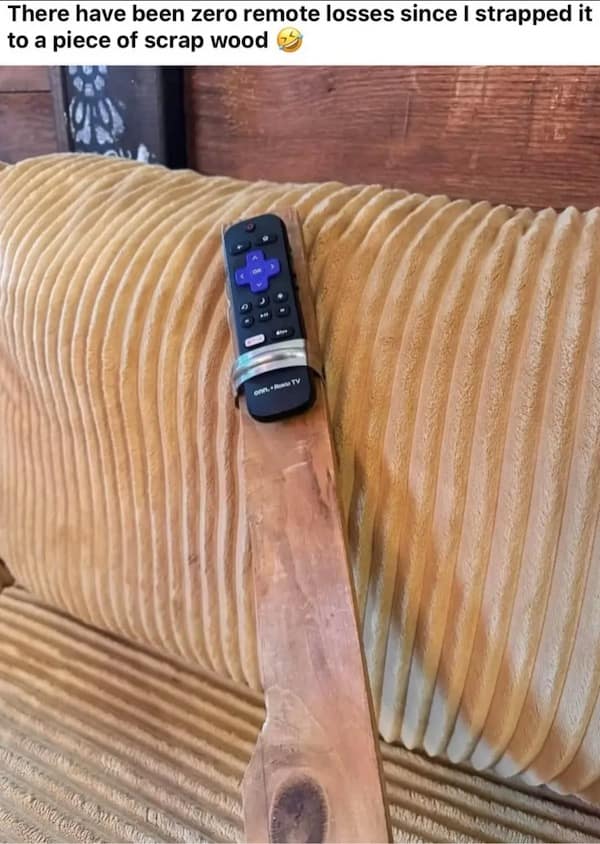 An aggressive feat of redneck engineering in this old meme, showing a Roku TV remote permanently clamped to a massive 2x4 piece of scrap wood to ensure "zero remote losses."