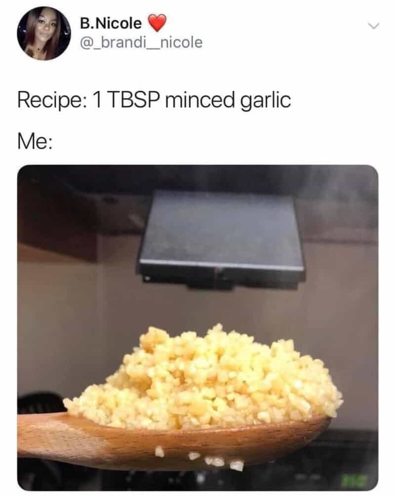 One of the most relatable chef memes showing an insanely massive, heaping wooden spoon overflowing with minced garlic, representing exactly how home cooks measure when a recipe strictly calls for "1 TBSP."