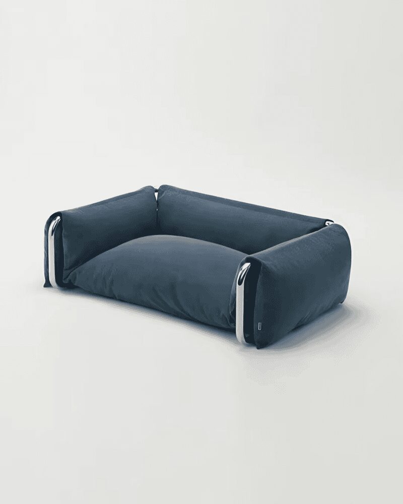 Minimalist dark blue cushioned pet sofa with a clean low-profile design and silver metallic frame accents.