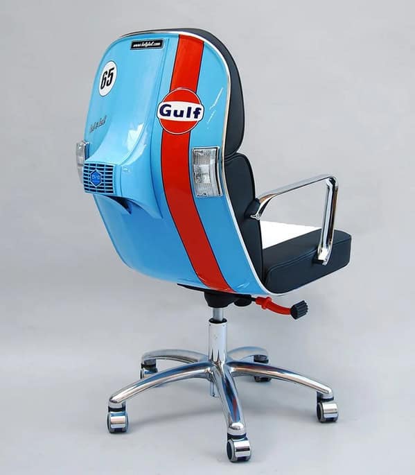 A weird furniture office chair constructed from the rear cowling of a vintage blue Gulf scooter, complete with tail lights and racing stripes.