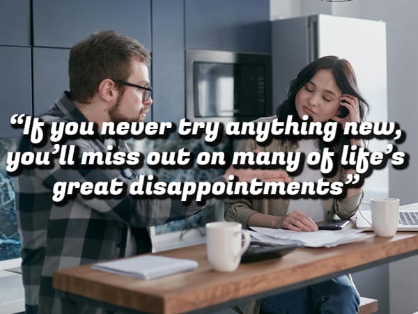 Two people looking stressed while sitting at a table with papers and a demotivational quote about disappointments.