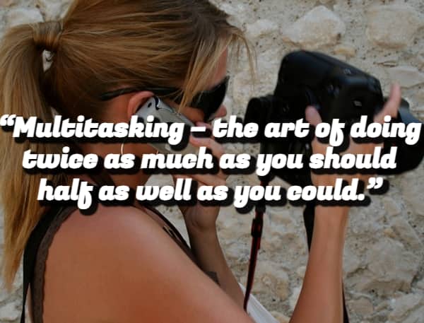 A woman holding a camera and talking on a phone with a demotivational quote about multitasking.
