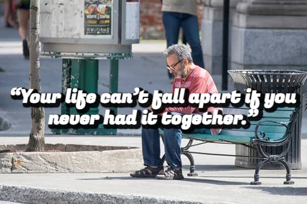 An older man sitting alone on a park bench with a demotivational quote about not having life together.