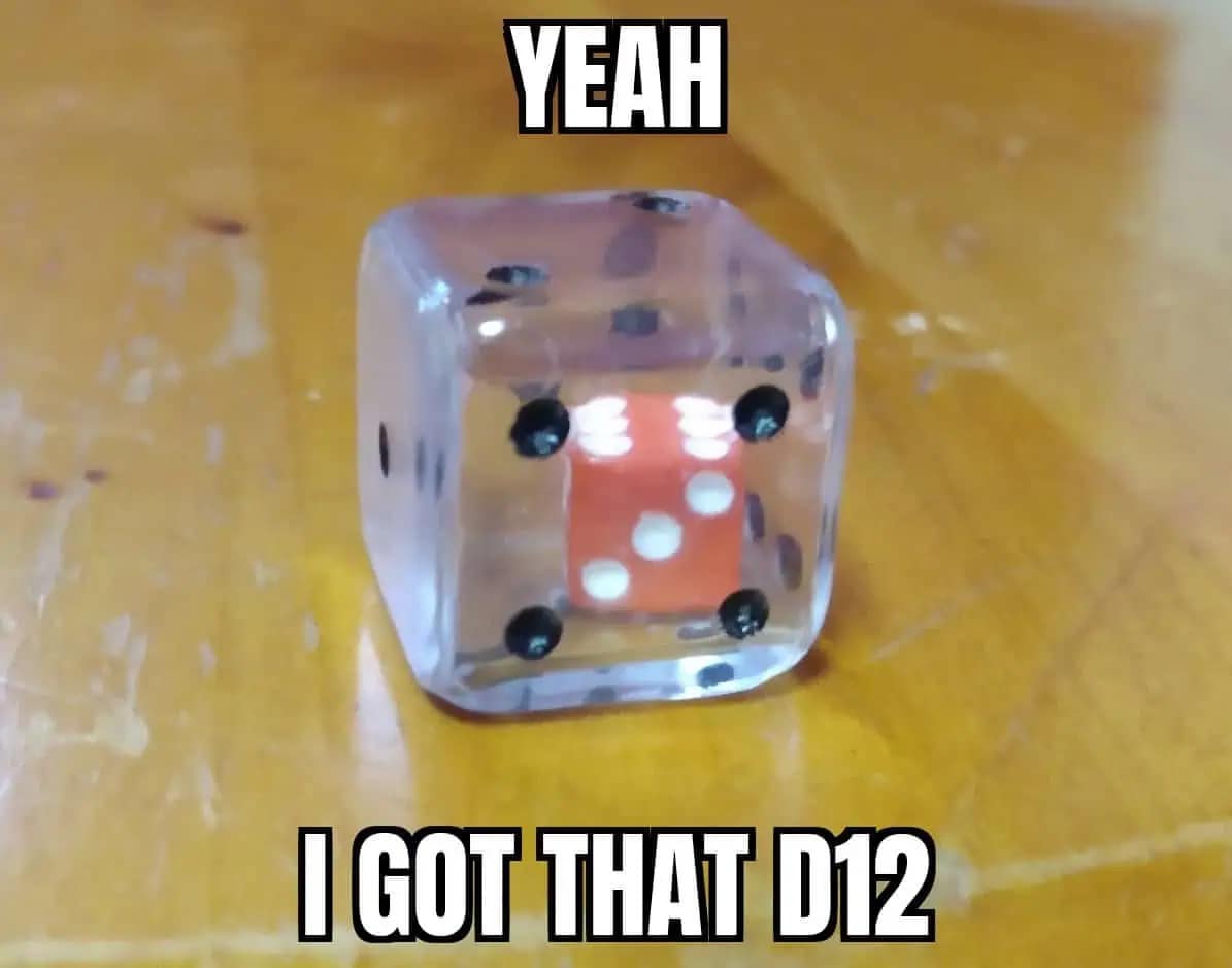 Clear d6 suspended inside a clear d12. Visual pun about rolling a twelve sided die for tabletop RPG games.