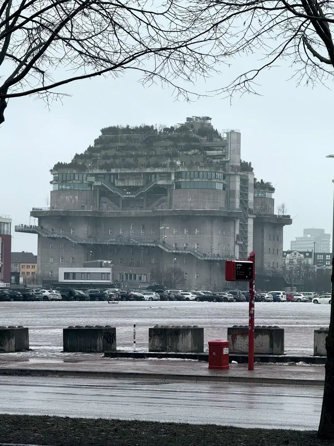 Massive concrete flak tower bunker in Hamburg recently renovated with a lush rooftop green space.