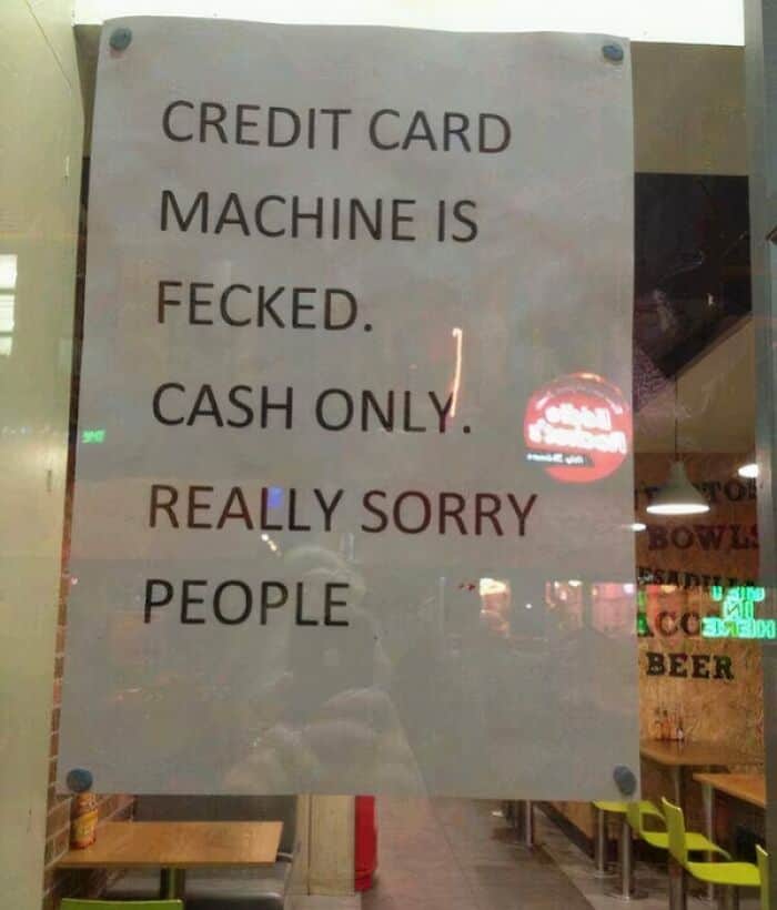 Blunt storefront sign stating the credit card machine is fecked and apologizing for the inconvenience.