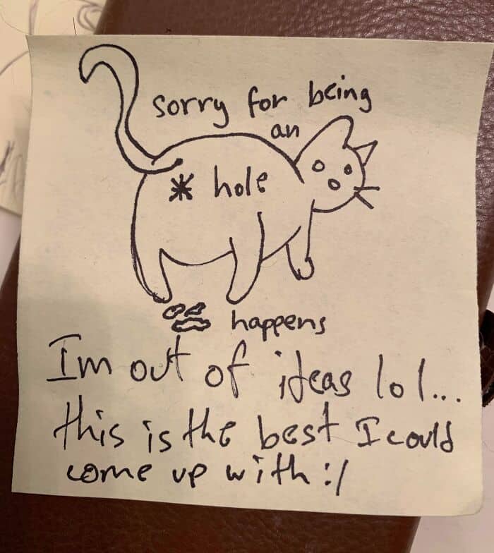 Sticky note featuring a crude drawing of a cat's backside and an apology for being an a-hole.