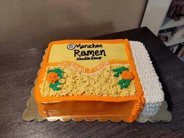 A funny cake realistically decorated to look exactly like a package of Maruchan chicken flavor ramen noodles.