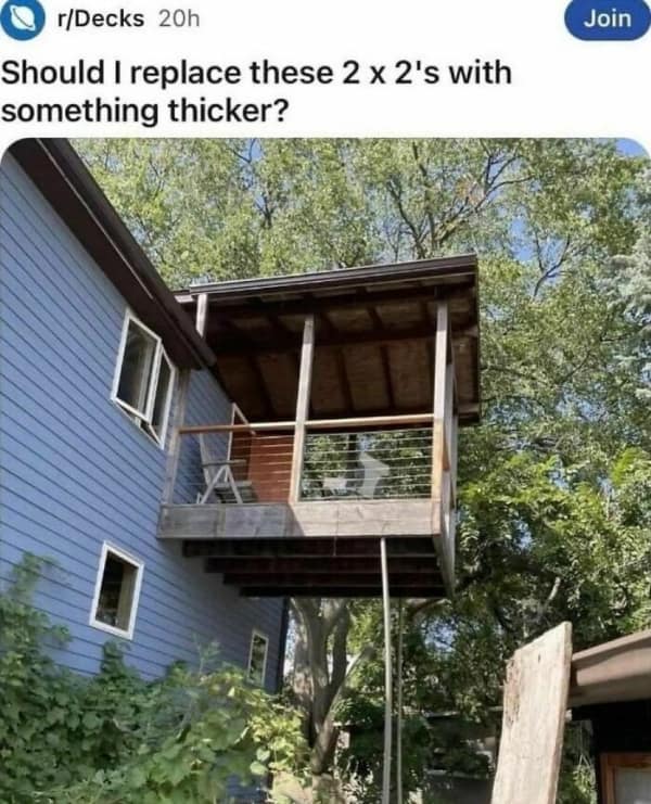 A terrifying architectural bad day photo featuring a heavy wooden balcony hanging off a house, supported by a single, absurdly thin piece of wood, asking "Should I replace these 2 x 2's with something thicker?"