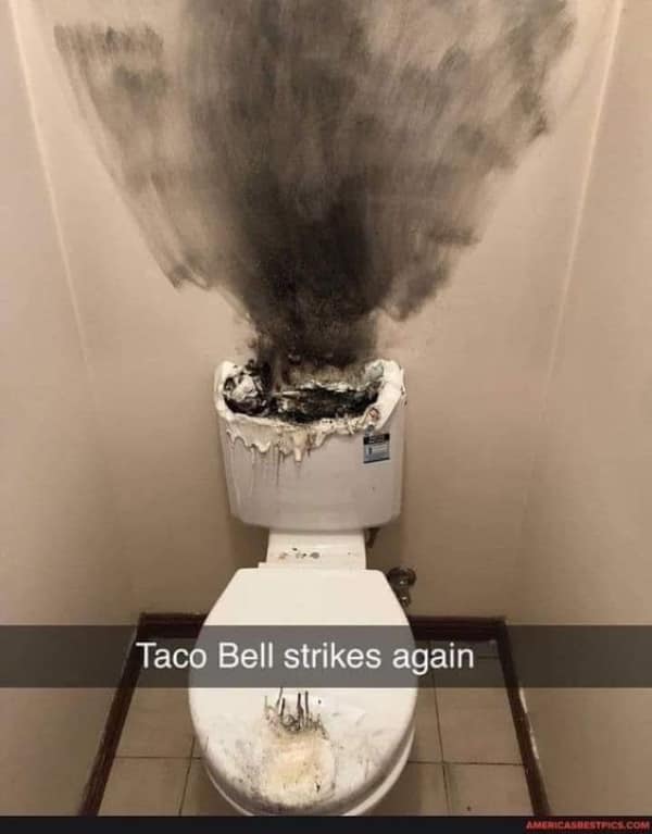 An explosive plumbing funny fail showing a toilet tank completely melted and destroyed by a massive fire, leaving thick black soot on the walls above a caption reading "Taco Bell strikes again."