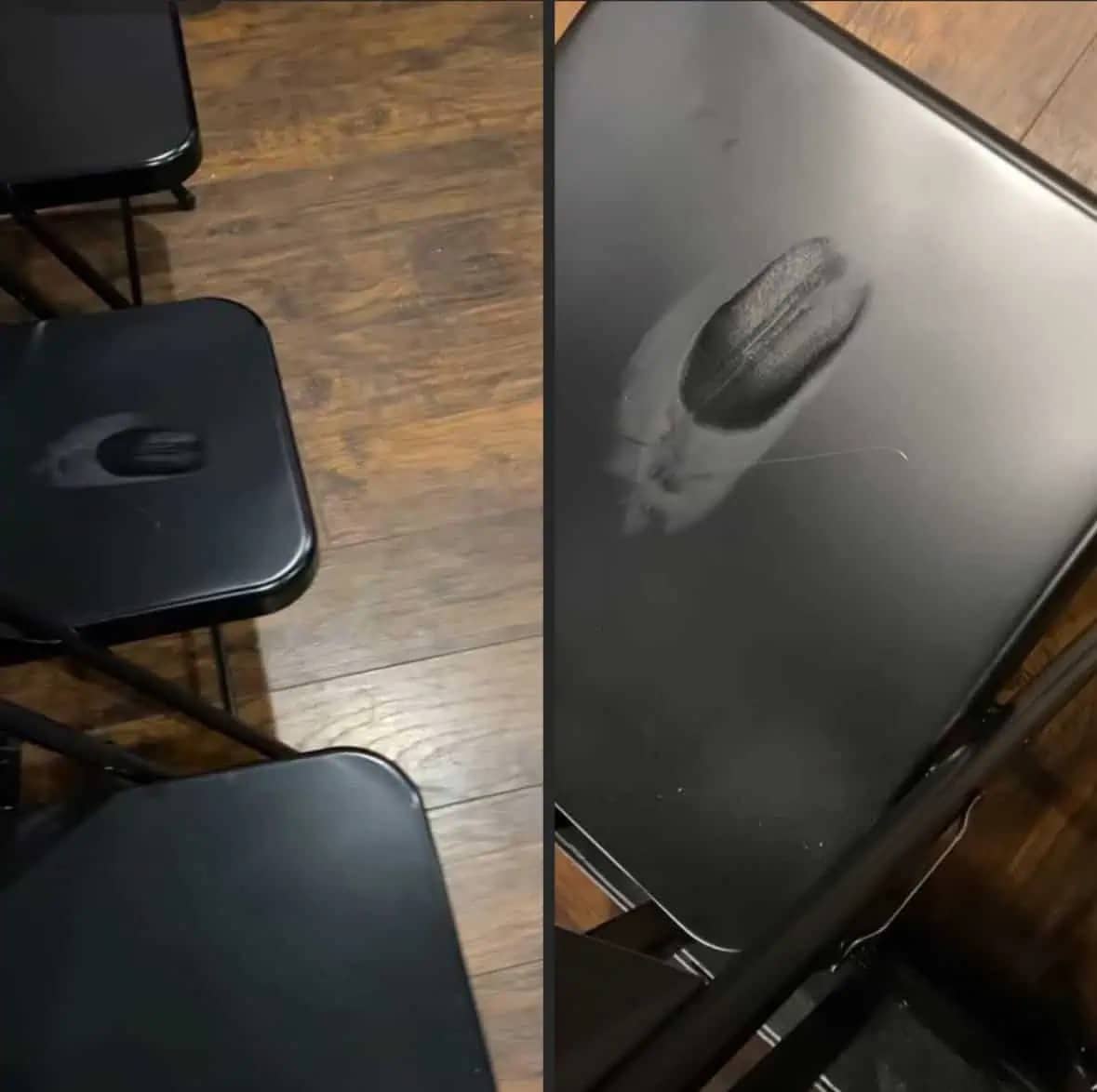 Funny close-up of a greasy hair mark left on a black chair, resembling a human face.