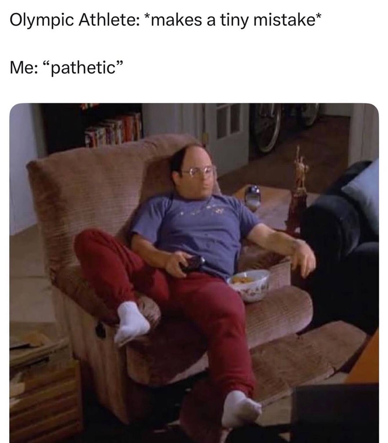 George Costanza sitting in a recliner judging an Olympic athlete's tiny mistake as pathetic meme.