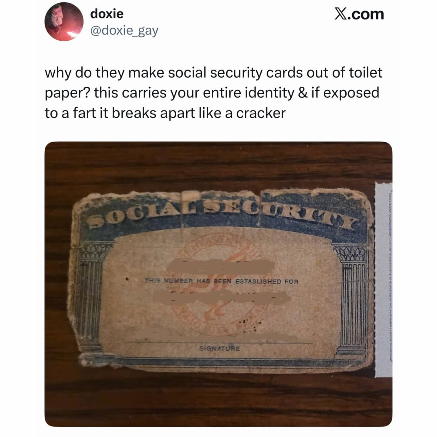 Tattered and worn-out United States Social Security card with a joke about its fragile quality.
