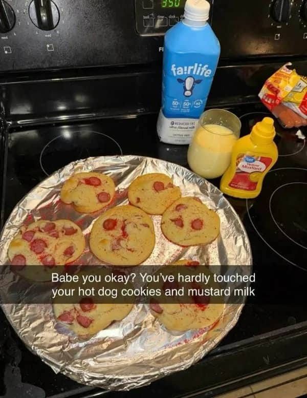 Funny cursed food image showing hot dog cookies on a pan next to mustard milk.