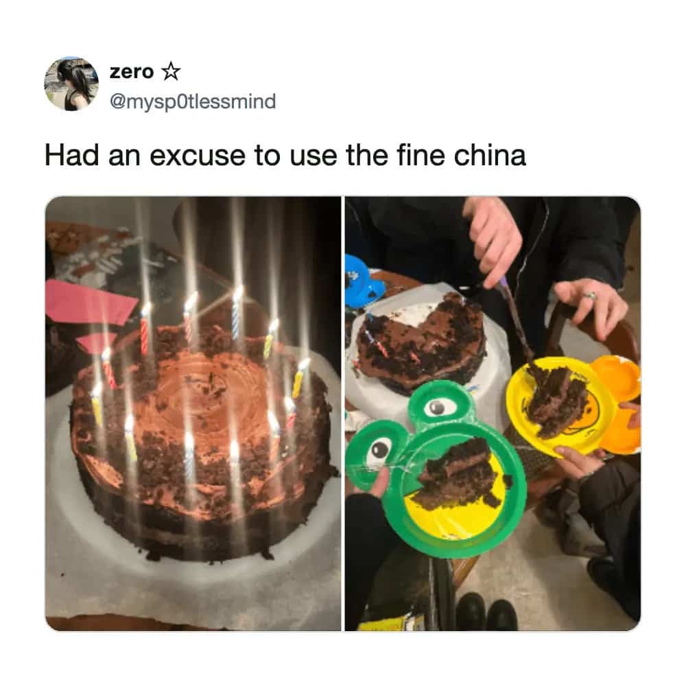 Chocolate birthday cake with many candles served on colorful children's frog-shaped plastic plates.