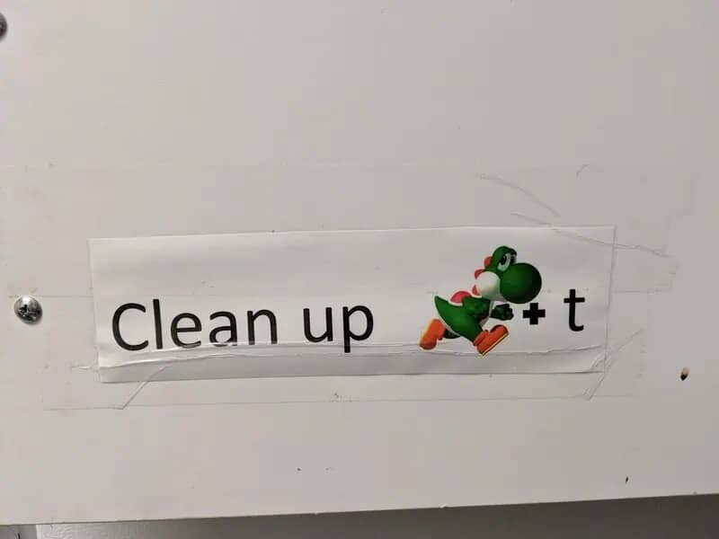 Punny office sign saying clean up yoshit using a Yoshi character and the letter t.