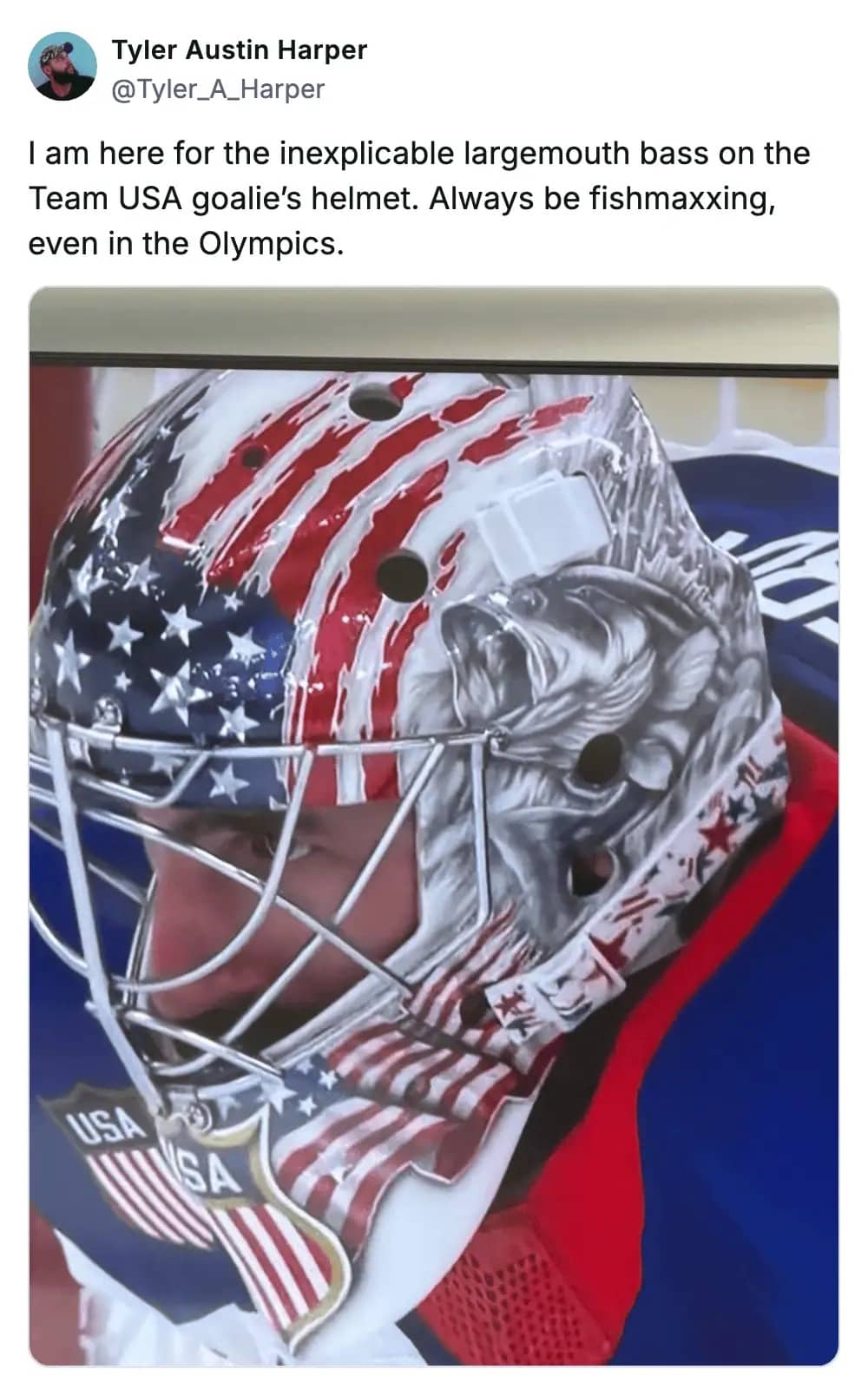 USA Olympic hockey goalie helmet featuring stars, stripes, and an unusual largemouth bass fish graphic.