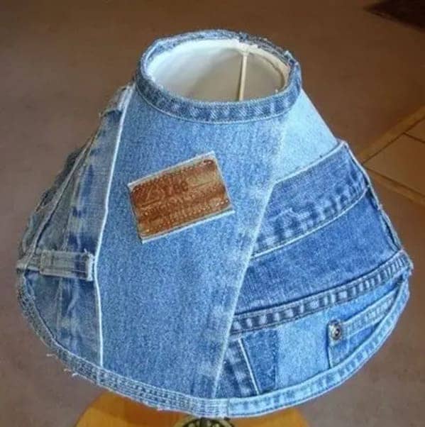 Table lampshade covered in denim fabric scraps with a visible brown Lee leather brand patch attached.