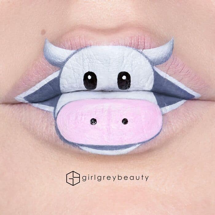 A wonderfully adorable amazing lip art transformation turning the lips into a cartoon cow, using the bottom lip perfectly as a large pink snout, showing off the fun character work of Andrea Reed lip art.