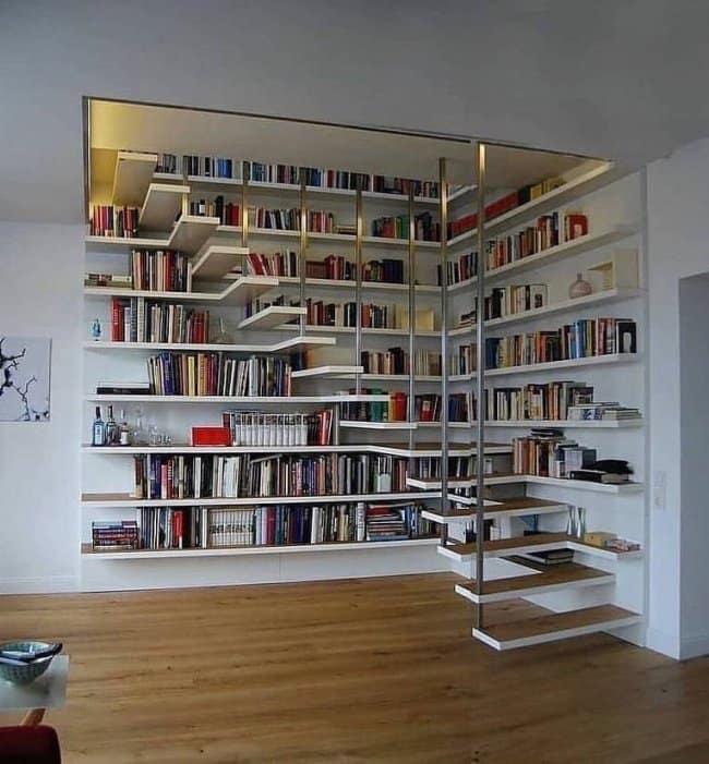 An architectural masterpiece awesome home decor library featuring floating white shelves that cleverly double as a functional staircase leading to a mezzanine level.