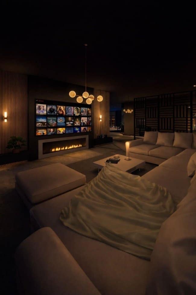 A sleek masculine home decor media lounge featuring a long linear fireplace beneath a large wall-mounted TV, creating the perfect cozy atmosphere for movie nights.