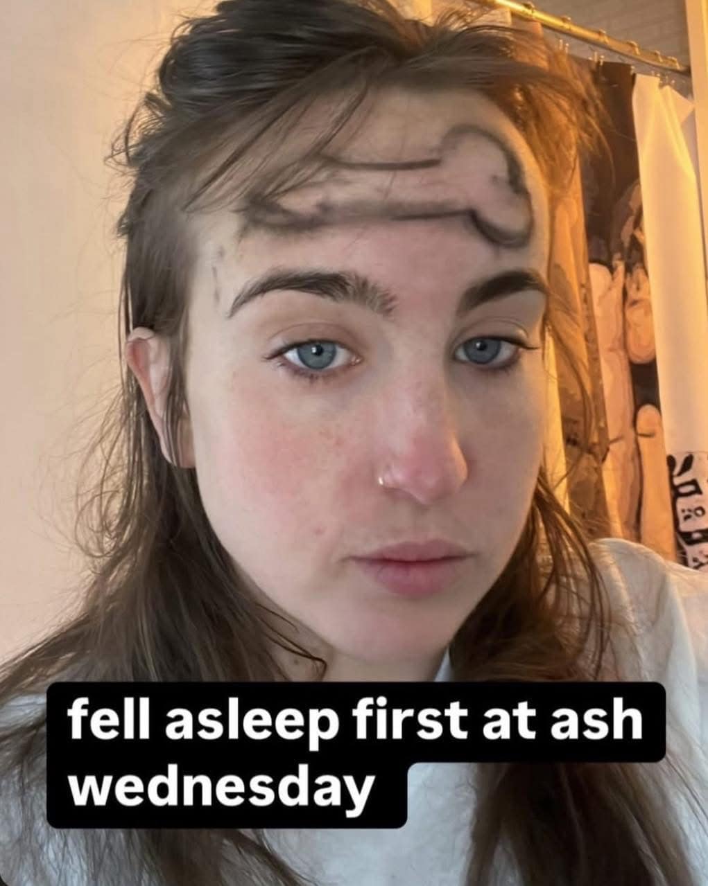 One of those truly hilarious memes showing a woman staring deadpan into the camera with a giant phallus drawn on her forehead, captioned with the ultimate Catholic joke: "fell asleep first at ash wednesday."