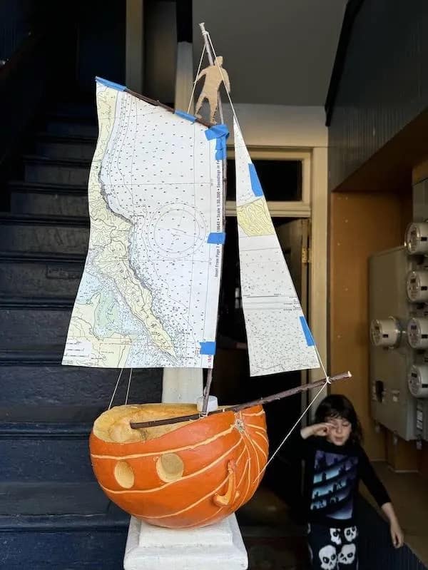 A creative meme dump image showing a pumpkin carved into a sailboat with sails made from nautical maps, manned by a cardboard sailor.