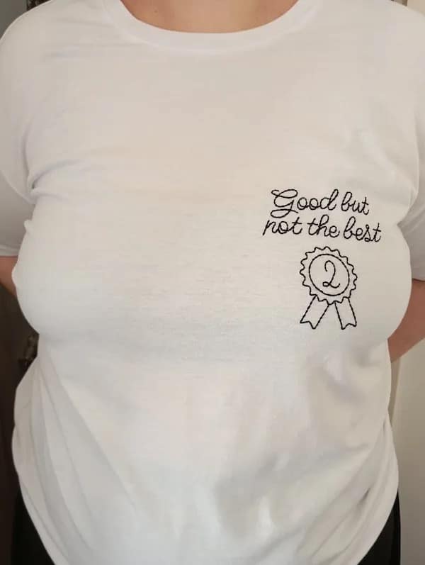 A humble-brag meme dump t-shirt embroidery placed over the chest reading "Good but not the best" underneath a second-place prize ribbon.