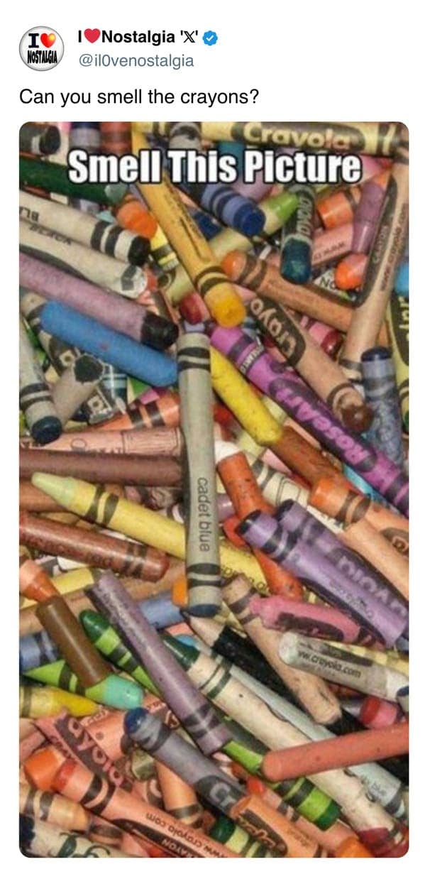 A sensory nostalgic photo of a massive pile of broken, well-used crayons, challenging the viewer to "Smell This Picture" and recall their distinct waxy classroom scent.