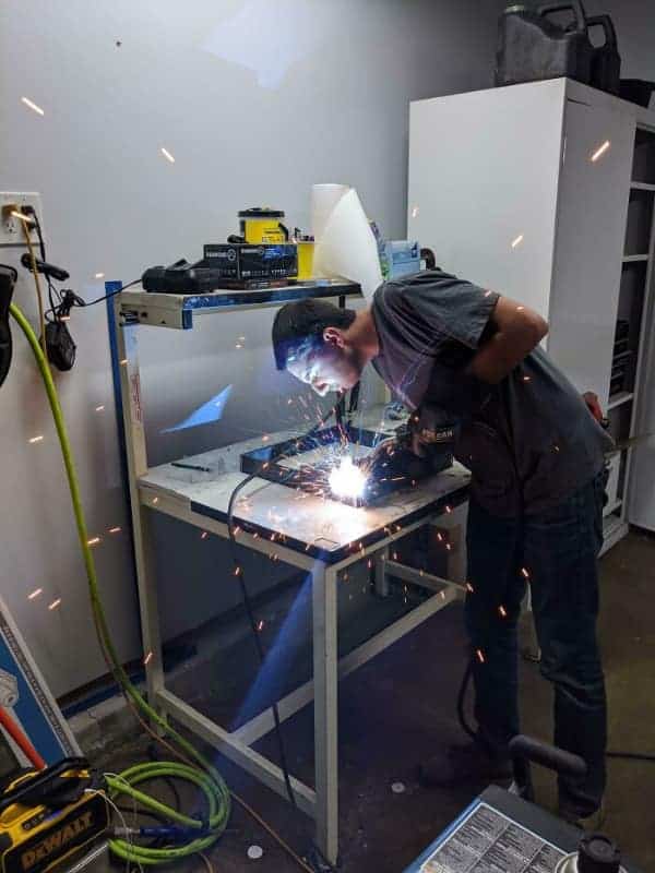A painful funny osha fail where a worker leans his face directly into the stream of hot sparks he is creating while grinding metal.