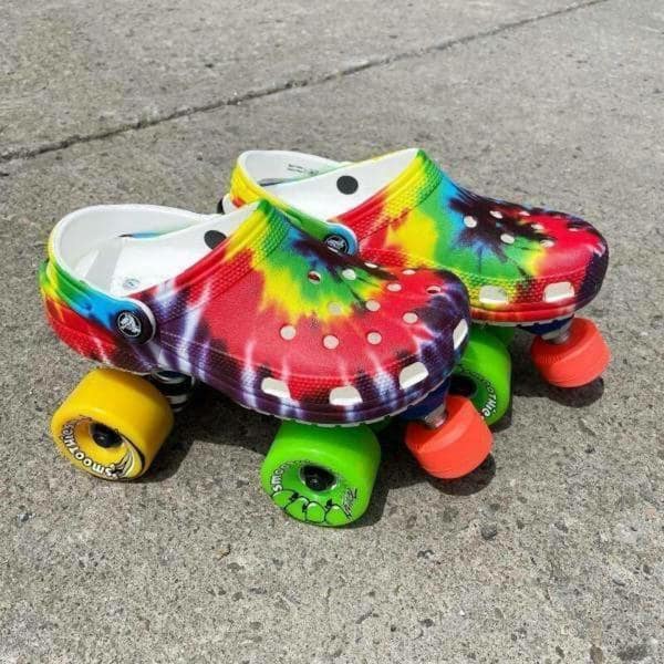 A redneck DIY creation showing tie-dye Crocs mounted onto skateboard wheels to function as roller skates.