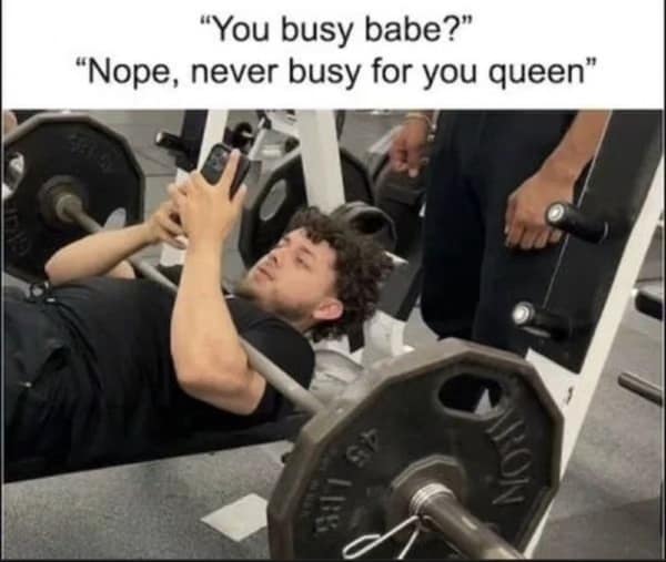 A wholesome relationship meme showing a "gym bro" pausing his bench press to immediately text back "never busy for you queen," prioritizing his partner over his gains.
