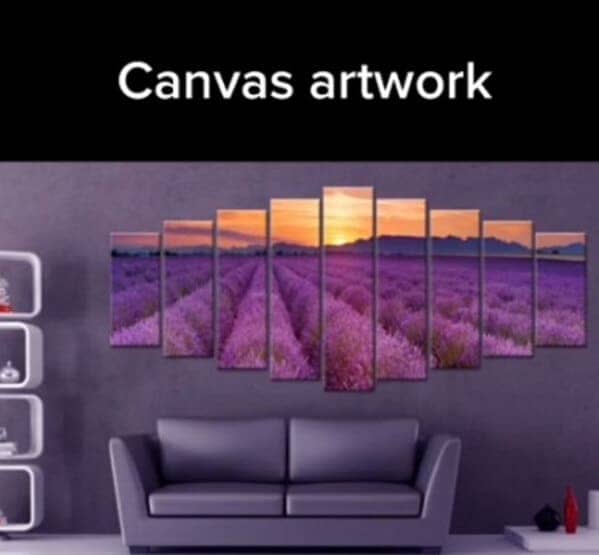 A multi-panel canvas artwork showing a purple lavender field at sunset hanging over a gray sofa.