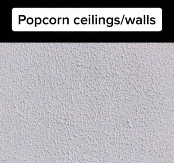 A close-up shot of a white wall or ceiling with a bumpy, textured popcorn finish.