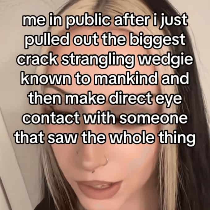 Woman looking down in public after a witness sees her fix a major wedgie.