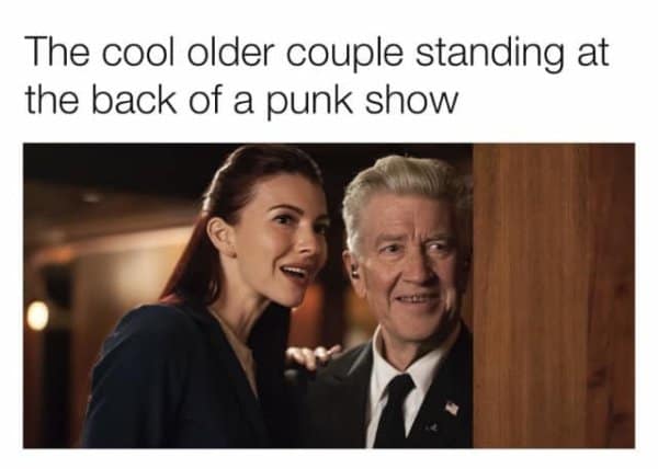 Gordon Cole and Tammy Preston smiling. A funny comparison to the cool older couple standing in the back of a punk rock show.