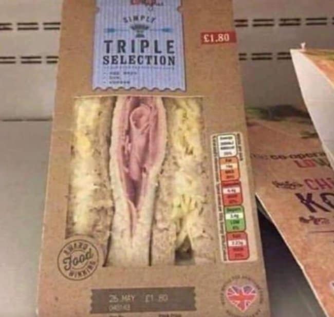 An unfortunate design on a grocery store shelf showing a pre-packaged "Triple Selection" sandwich, where the intricately folded pink ham in the middle slice looks completely and accidentally nsfw.