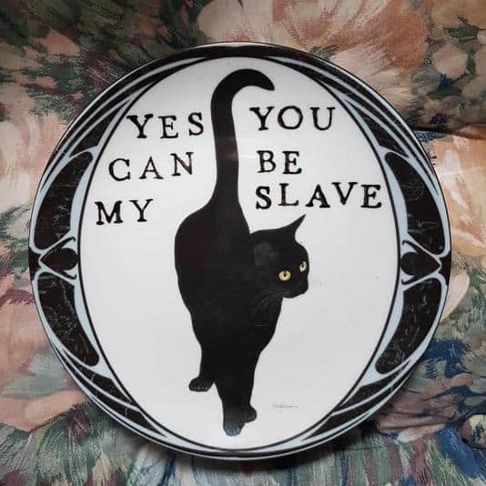 Decorative plate featuring a black cat with text saying yes you can be my slave.