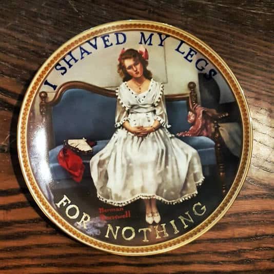 Plate featuring a woman in a white dress on a sofa with text about shaving for nothing.