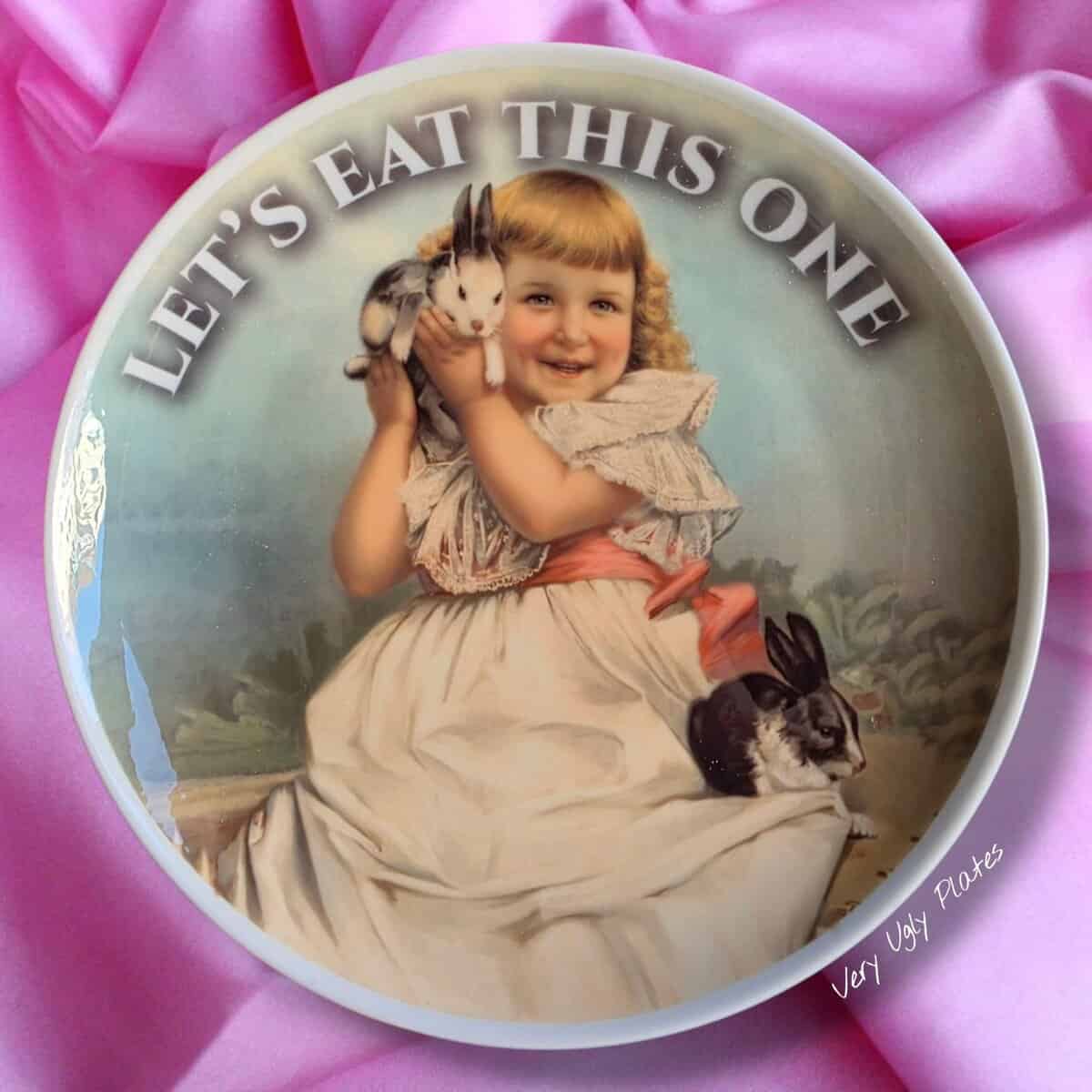 Plate depicting a girl holding a rabbit with text suggesting that they should eat this one.