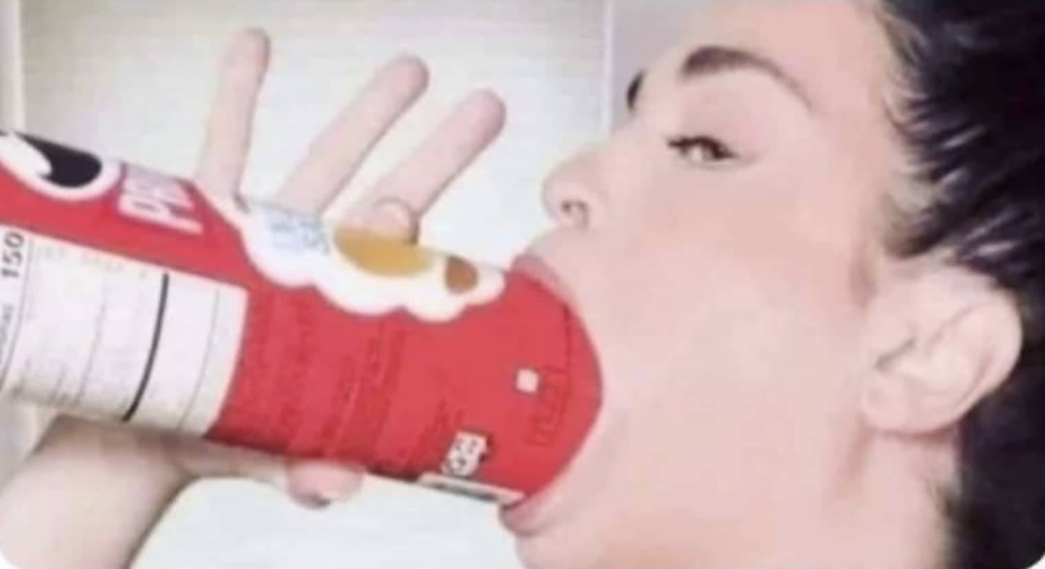 Viral image of a woman fitting an entire red Pringles can into her open mouth.