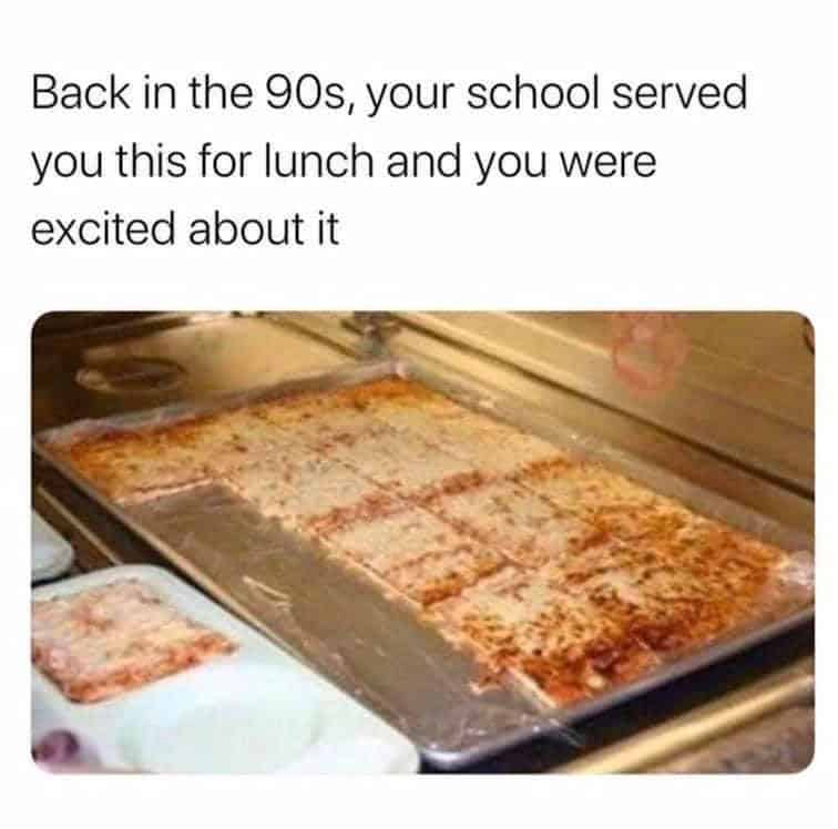 A culinary 90s meme featuring a large, rectangular cafeteria sheet pizza resting in a metal warming tray. The text notes how this specific school lunch was a source of genuine excitement for kids of the era.