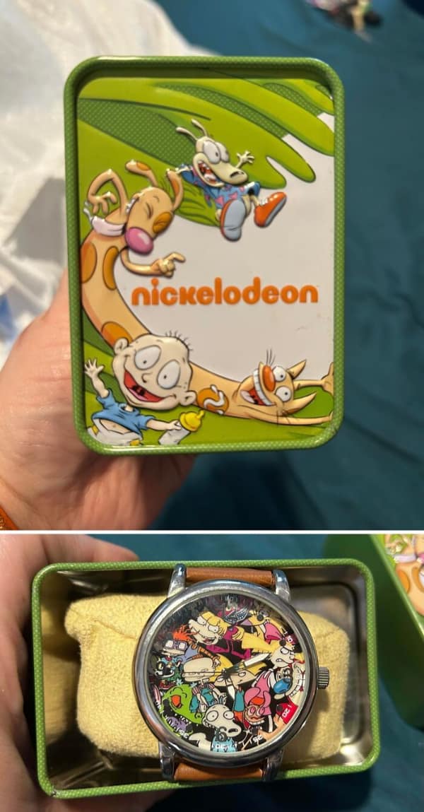 A vintage Nickelodeon watch covered in beloved cartoon characters like Rugrats and Rocko's Modern Life inside its original green tin, serving as a perfect piece of 90s nostalgia in this 90s meme.