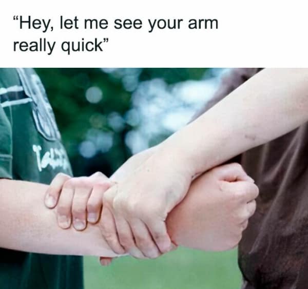 A painful piece of 90s nostalgia captured in a funny 90s meme showing a kid innocently asking to see their friend's arm really quick before immediately delivering a ruthless two-handed Indian burn twist to their skin.